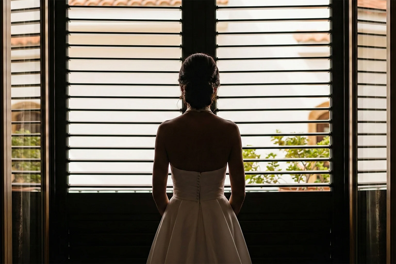 Silhouette of the bride standing by a window before the wedding ceremony in Cologne (Köln), NRW, Germany