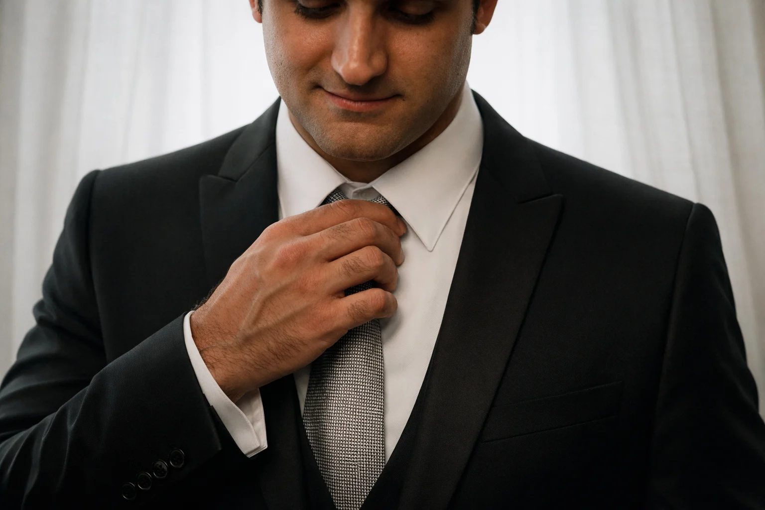 Groom adjusting his tie while getting ready for the wedding in Oberhausen, NRW, Germany