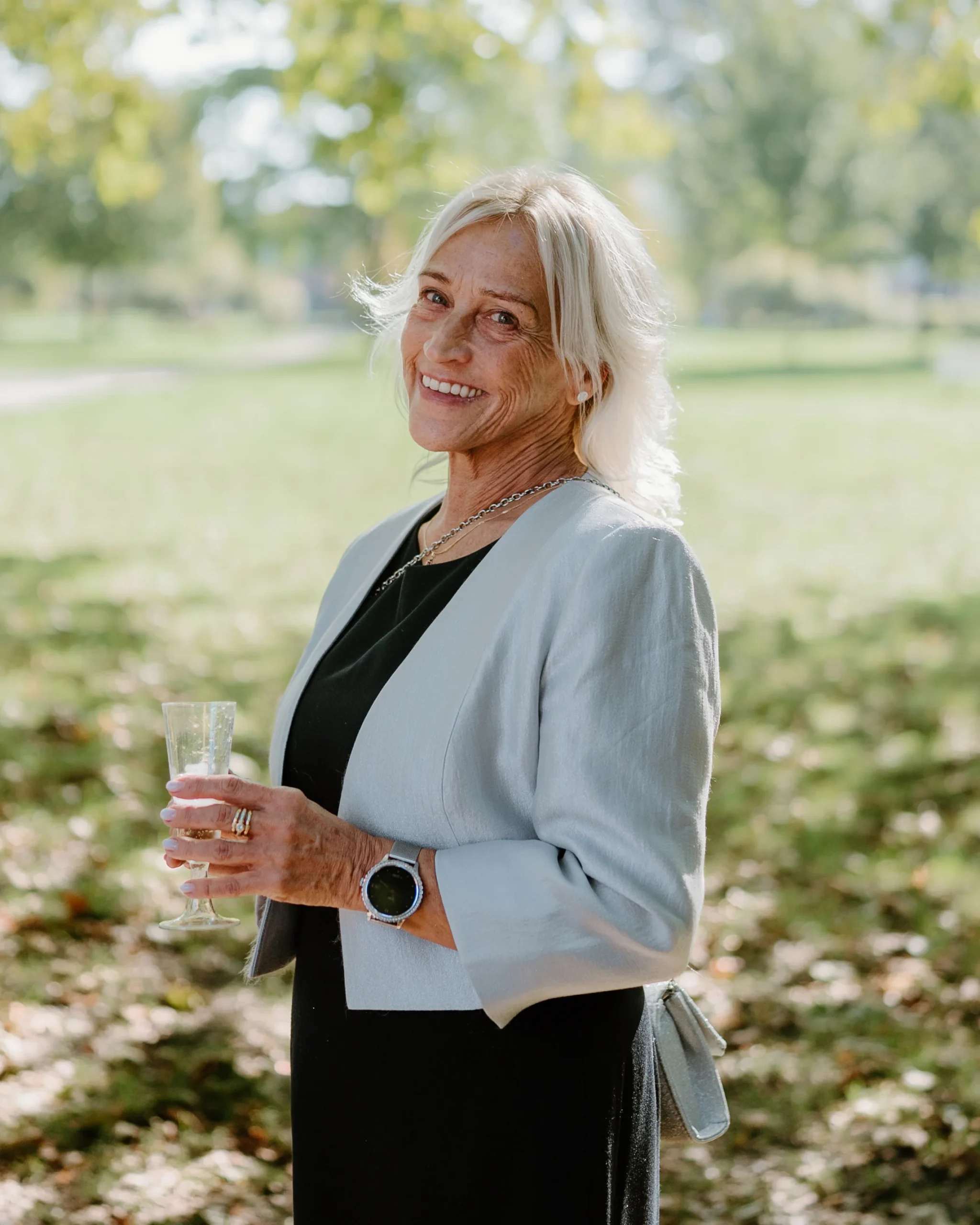 Smiling mother of the bride holding a glass of champagne during the wedding celebration in Gelsenkirchen