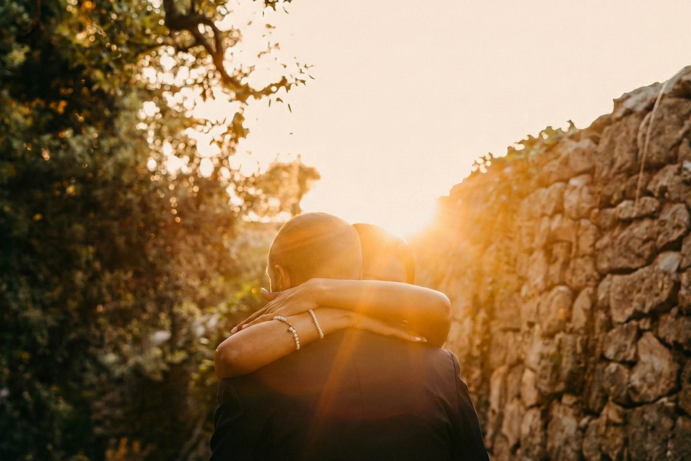 Wedding couple embracing at sunset in Puglia during a romantic golden hour moment
