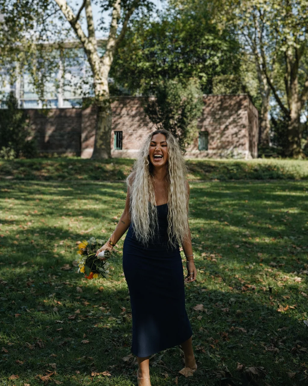 Happy wedding guest holding the bouquet after catching it during the celebration in Gelsenkirchen